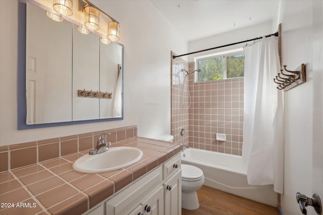 full bathroom with hardwood / wood-style floors, shower / bath combo, toilet, and vanity