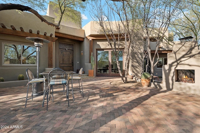 view of patio / terrace with exterior fireplace and french doors