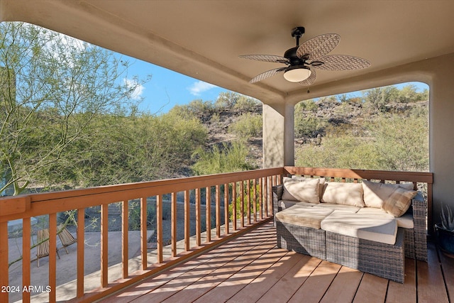 wooden terrace featuring outdoor lounge area and ceiling fan