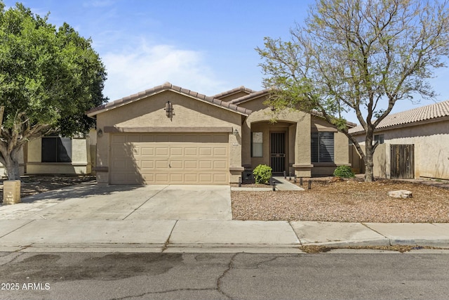 2932 N 115th Ln, Avondale, AZ 85392 - mediterranean / spanish house with an attached garage, concrete driveway, stucco siding, and a tile roof