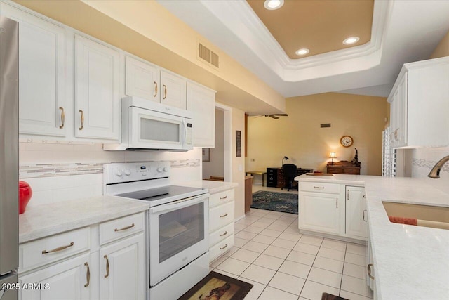 kitchen with sink, white cabinets, white appliances, and decorative backsplash