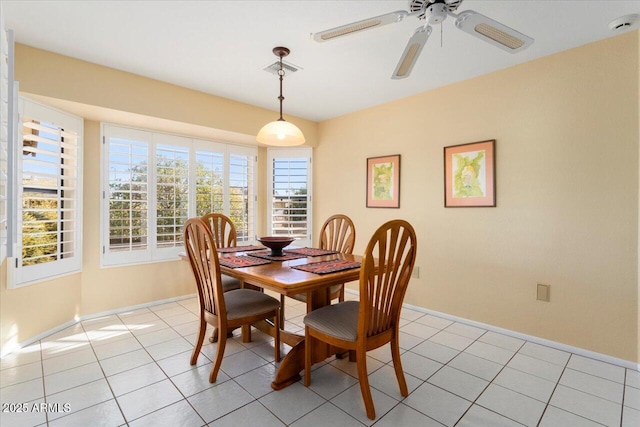 tiled dining room featuring ceiling fan