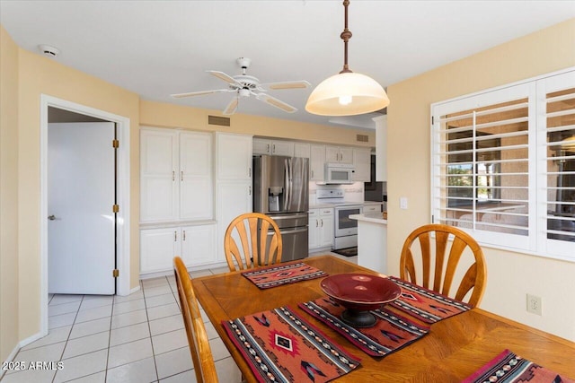 dining area featuring ceiling fan and light tile patterned floors