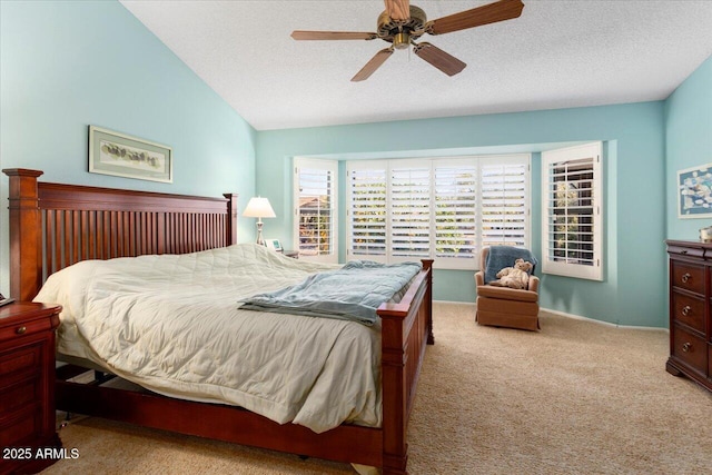 bedroom with ceiling fan, lofted ceiling, light carpet, and a textured ceiling