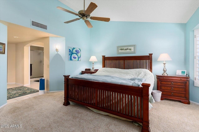 bedroom with high vaulted ceiling, light carpet, and ceiling fan