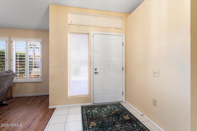 entryway with tile patterned flooring and a textured ceiling