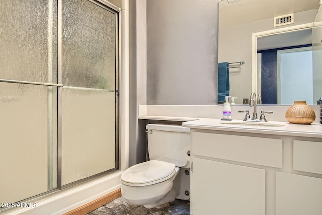 bathroom with vanity, toilet, and walk in shower