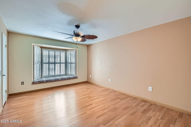 spare room featuring ceiling fan and light wood-type flooring