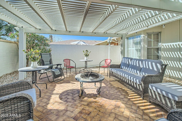 view of patio / terrace with a pergola and an outdoor living space with a fire pit