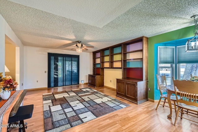 living room with light hardwood / wood-style floors and ceiling fan