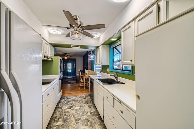 kitchen with dishwasher, white refrigerator, white cabinetry, and sink