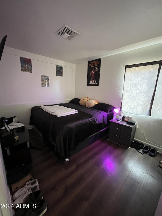 bedroom with wood-type flooring