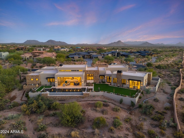 back house at dusk featuring a mountain view