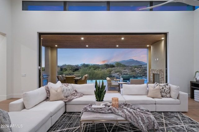 living room featuring hardwood / wood-style floors and a towering ceiling