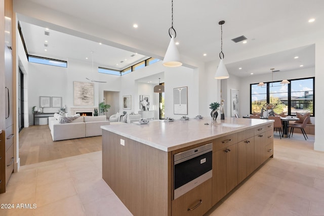 9940 E Aleka Way, Scottsdale, AZ 85262 - kitchen featuring open floor plan, a sink, modern cabinets, a spacious island, and light stone counters