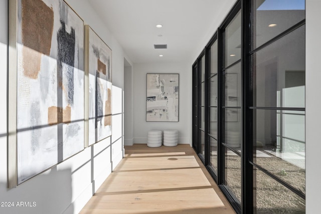 hall with light hardwood / wood-style flooring