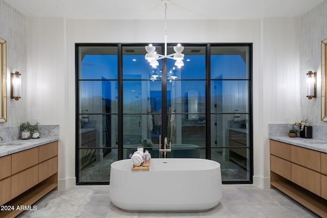 9940 E Aleka Way, Scottsdale, AZ 85262 - bathroom featuring two vanities, a chandelier, and a freestanding bath