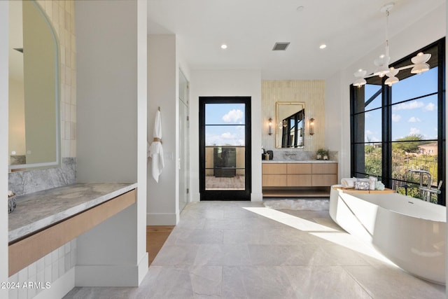 9940 E Aleka Way, Scottsdale, AZ 85262 - full bathroom with a freestanding bath, vanity, backsplash, recessed lighting, and baseboards