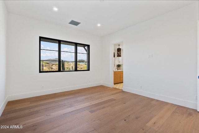 spare room with light wood-type flooring