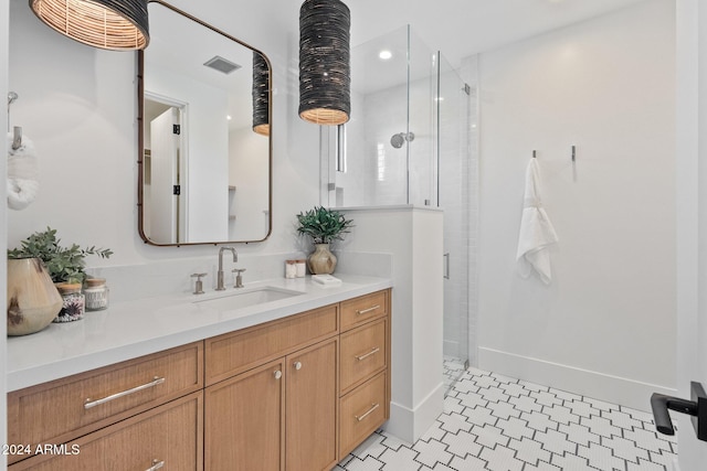 bathroom featuring tile patterned flooring, vanity, and an enclosed shower