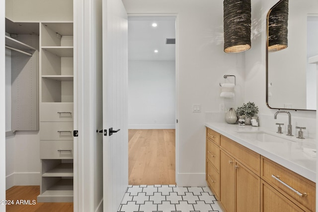 bathroom with wood-type flooring and vanity