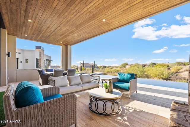 wooden deck with a patio area and an outdoor hangout area