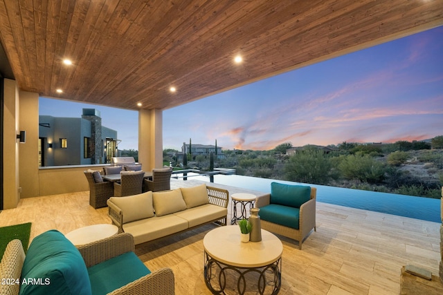 9940 E Aleka Way, Scottsdale, AZ 85262 - patio terrace at dusk with an outdoor hangout area, a patio, and exterior kitchen