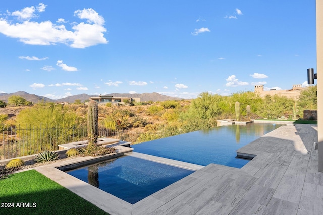 exterior space with a mountain view and a fenced in pool