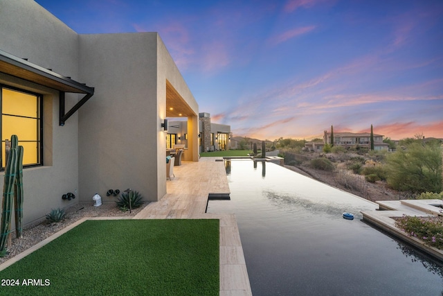 view of patio terrace at dusk