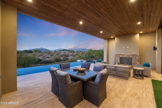 9940 E Aleka Way, Scottsdale, AZ 85262 - view of patio with an outdoor stone fireplace, a mountain view, and outdoor dining area