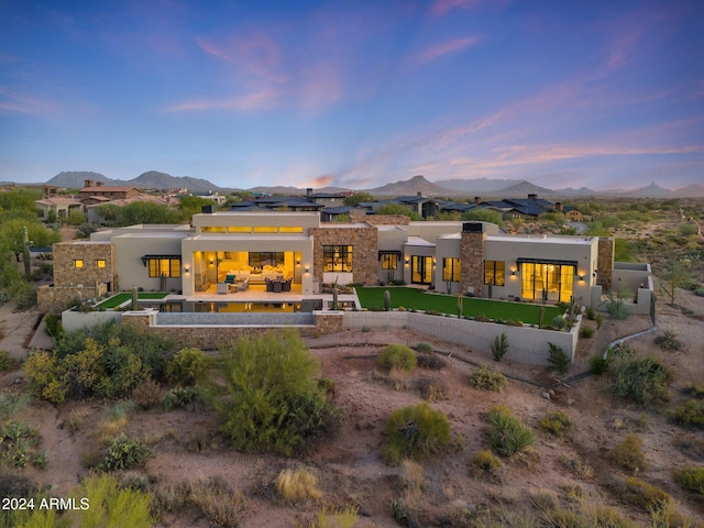 9940 E Aleka Way, Scottsdale, AZ 85262 - back of house featuring a mountain view, a fenced backyard, french doors, stucco siding, and a patio area