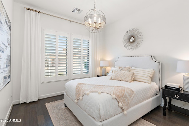 bedroom featuring baseboards, a notable chandelier, visible vents, and dark wood-style flooring