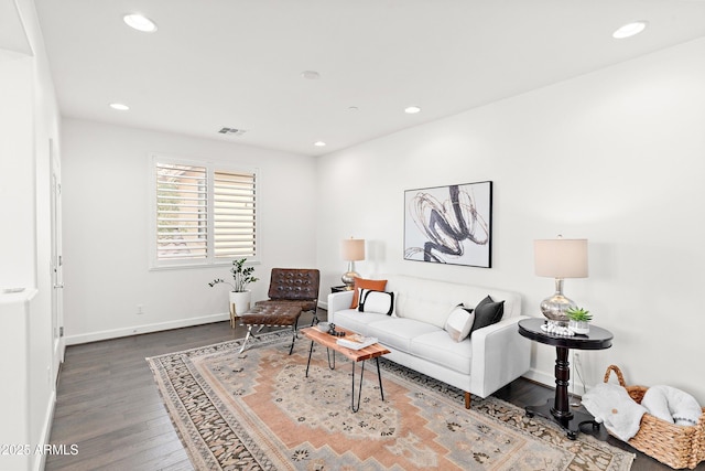 living area with recessed lighting, dark wood-style flooring, visible vents, and baseboards