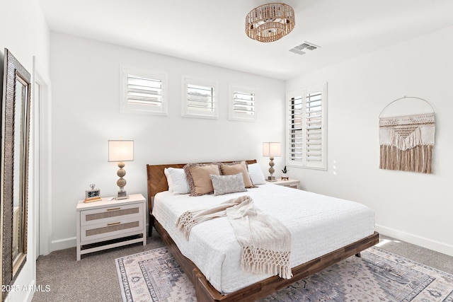 bedroom featuring dark carpet, visible vents, and baseboards