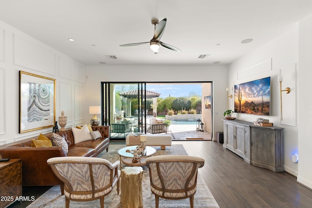 living room with a ceiling fan, dark wood-style flooring, and visible vents