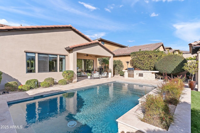 outdoor pool with a patio, area for grilling, and a ceiling fan