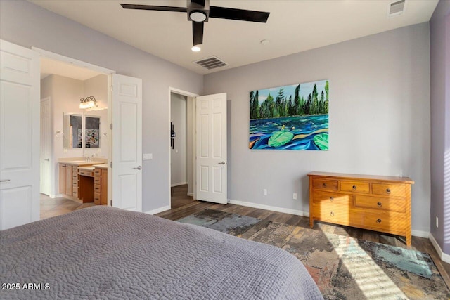 bedroom featuring ceiling fan, dark hardwood / wood-style flooring, and ensuite bath