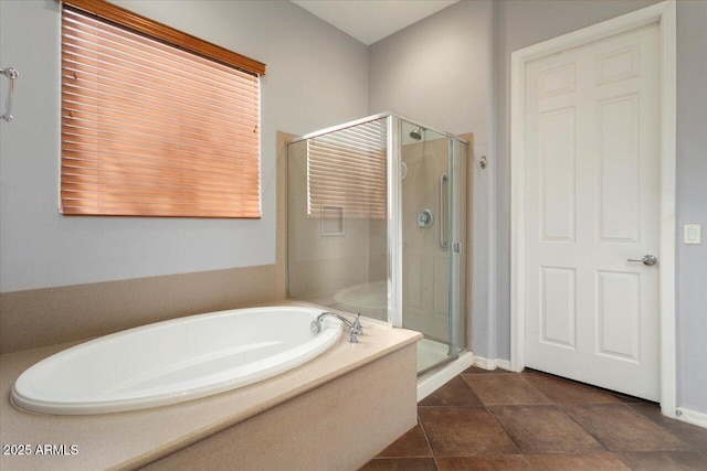 bathroom featuring tile patterned floors and independent shower and bath