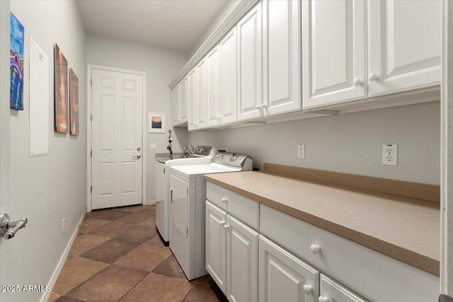 laundry area with cabinets and washer and clothes dryer