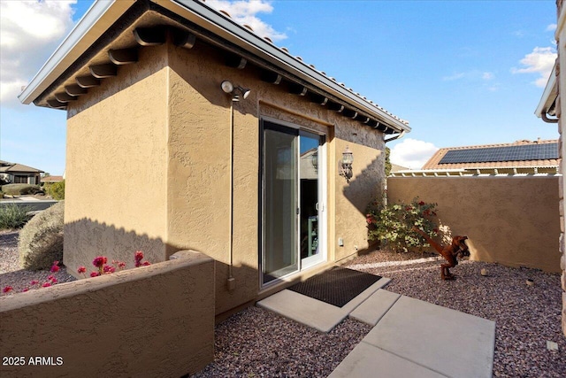 rear view of house featuring solar panels