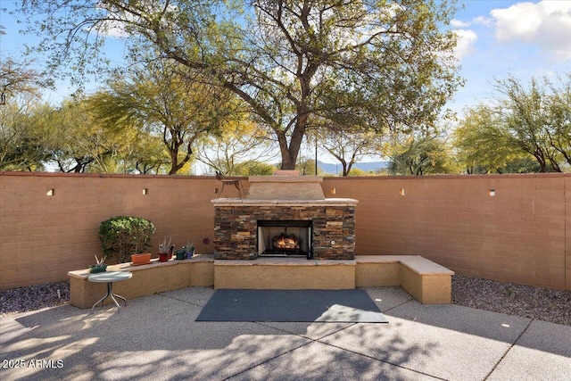 view of patio with an outdoor stone fireplace