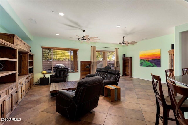 tiled living room featuring ceiling fan and plenty of natural light