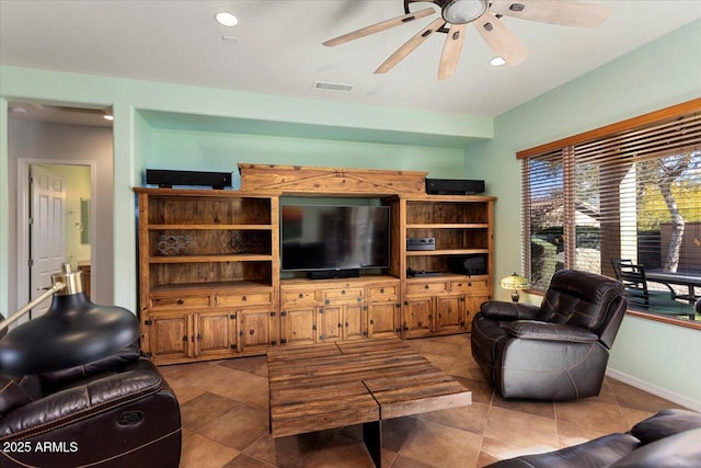 living room featuring ceiling fan and tile patterned flooring