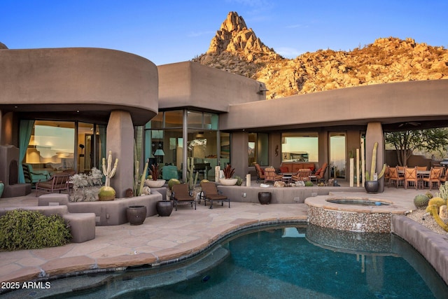 view of pool with a patio area and an in ground hot tub