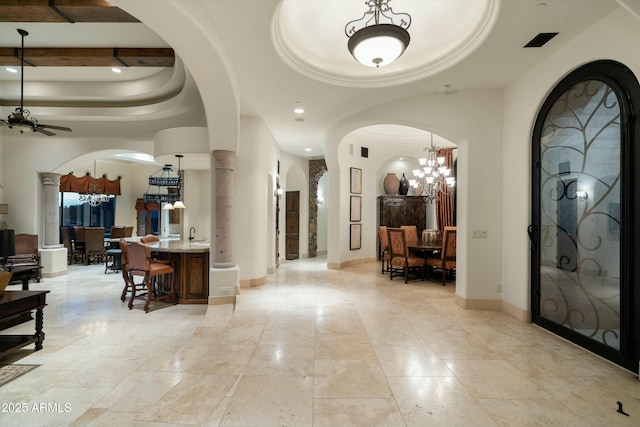 entrance foyer with ceiling fan with notable chandelier and sink