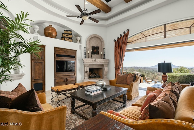 living room featuring ceiling fan and beam ceiling