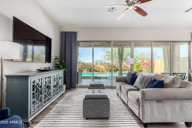 living room with ceiling fan and wood-type flooring