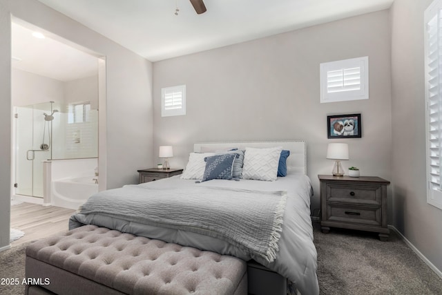 carpeted bedroom with connected bathroom and ceiling fan