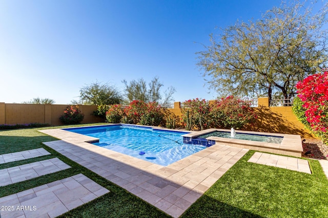 view of pool with an in ground hot tub, a patio area, and a lawn