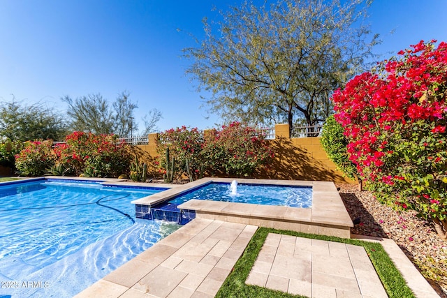 view of pool with pool water feature and an in ground hot tub